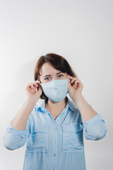 girl in a medical mask from kovid19 blue on a white background