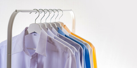 Men's dress shirts, Clothes on hangers on white background