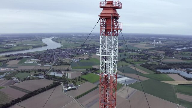 Aerial view of a man BASE jumping from an antenna in the early morning in Germany