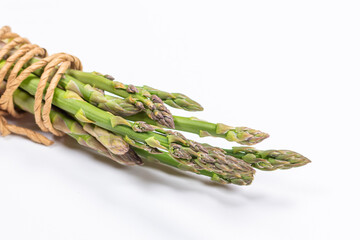 Green and white fresh asparagus on a gray background