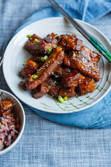 sweet and sour pork ribs in a plate under natural light