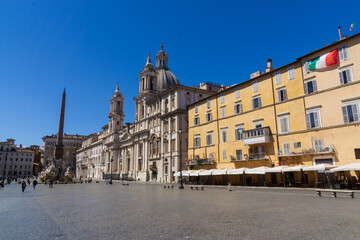 Fototapeta na wymiar Fountain of the Four Rivers with an Egyptian obelisk and Sant Agnese Church on the famous Piazza Navona Square in the morning, Rome, Italy