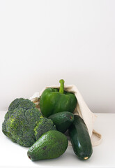 Photo of a bunch of vegetables with a reusable bag