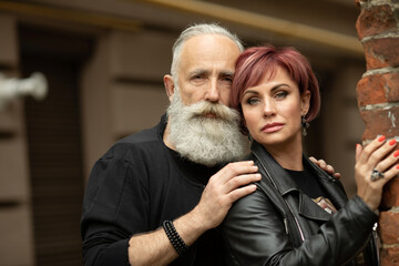 Bearded Senior man and woman wearing leather jackets. Happy couple of retirees in biker clothes.