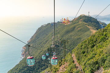 The sunny view of cable car and theme park near to ocean