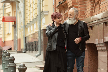 Bearded Senior man and woman wearing leather jackets. Happy couple of retirees in biker clothes.