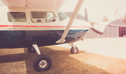 Small tourist plane at the airport near the hangar. Aeroclub airport.