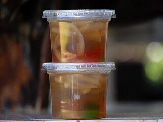 Jelly is packaged in plastic glass.