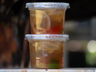 Jelly is packaged in plastic glass.