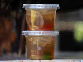 Jelly is packaged in plastic glass.