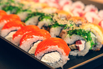 traditional japanese sushi set serviced on black background. tasty set of sushi, nigiri, sashimi and maki.