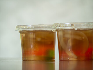 Jelly is packaged in plastic glass.