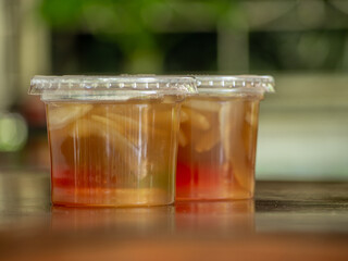 Jelly is packaged in plastic glass.