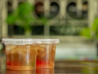 Jelly is packaged in plastic glass.