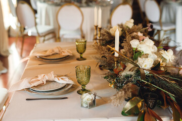Presidium table setting with green wine glasses and candles
