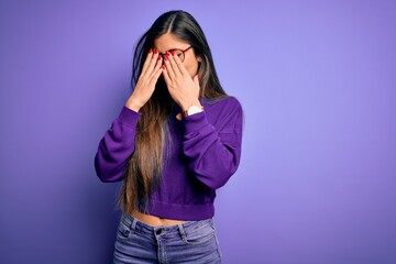 Young beautiful smart woman wearing glasses over purple isolated background rubbing eyes for fatigue and headache, sleepy and tired expression. Vision problem
