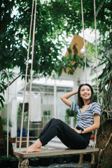 Portrait of a beautiful woman smiling and swinging in her house