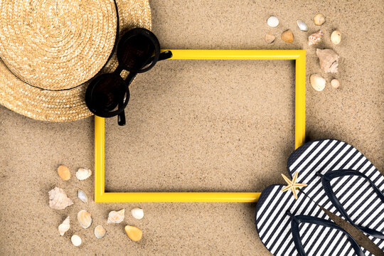 Yellow photo frame and Beach accessories.Summer time vacation concept.