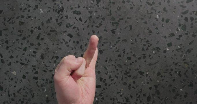 Slow motion top view man hand count over concrete background