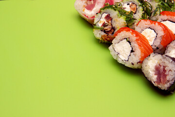 Large set of Delicious sushi rolls with copy space. A lot assortment Philadelphia roll Dishes from Japanese raw fish in one plate in traditional restaurant.