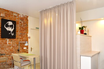 Fototapeta na wymiar Zoning of beauty salon room with curtains