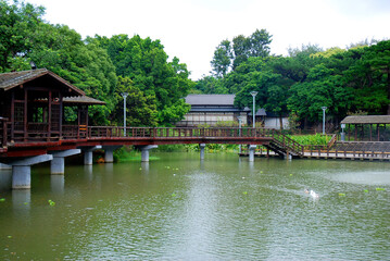 Hsingchu, Taiwan park area with pond and traditonal architecture buildings