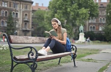 young woman read a book on a bench
