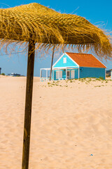 Fototapeta premium Costa de Caparica is the famous tourist destination, with the typical tiny colorful house, big sandy beaches, and the ocean waves. 