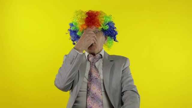 Senior clown businessman entrepreneur boss making silly faces