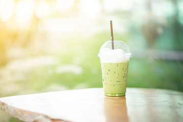 Iced green tea placed on the table background blurred