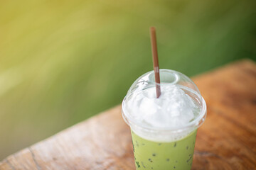 Iced green tea placed on the table background blurred