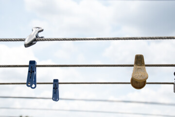 Various plastic clothespin colorful on clothes line.