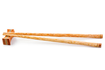 wooden chopsticks and chopsticks rest isolated on white background