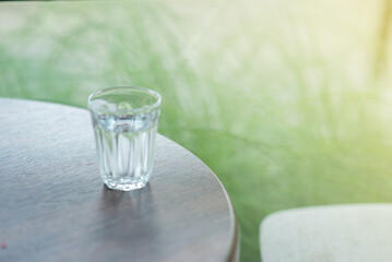A small glass of water filled with water placed on the table