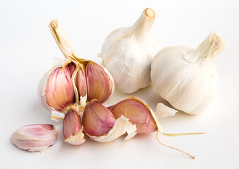 garlic heads and cloves on white background