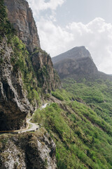 Fototapeta na wymiar Mountain road on a steep slope mountain trip