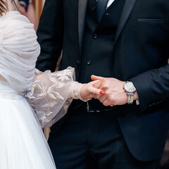 bride and groom hold hands