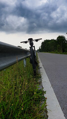 Fototapeta na wymiar The bicycle on cloudy background.