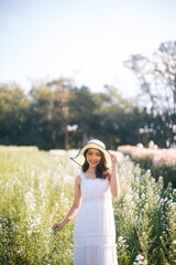 outdoor portrait of a beautiful asia woman. attractive cute girl in a field with flowers