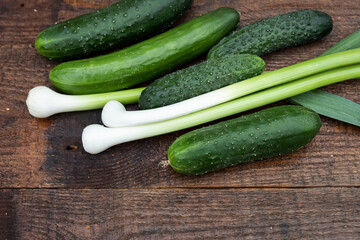 On the board are cucumbers and onions.
