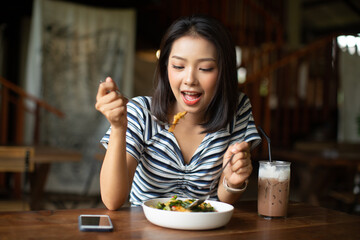Young Asia woman eating spaghetti at restaurant