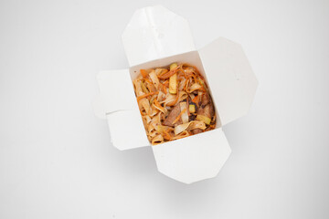 Chinese noodles in a box. Take away delivery. Pork in sweet and sour sauce.