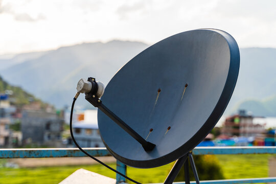 Household parabolic sattelite dish antenna for TV channels and internet, stock photo