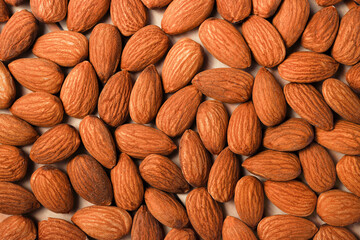 Organic peeled brown almond nuts top view good for background. concept of vegan raw ingredient for vegetarian, snack and healthy food.