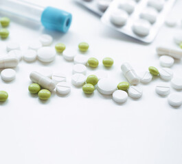 A health examination using a blood test and treatment with pills according to the results of the examination on a white table with an empty place for text