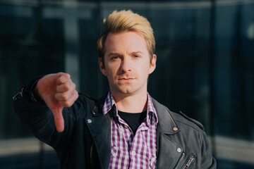 The face of the man who put his finger down. The concept of discontent on a beautiful background