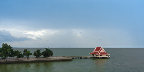 Red Thai style house in clear sky background : Phatthalung, THAILAND - July 8 , 2019 : King statue in beautiful sky at Lampam beach