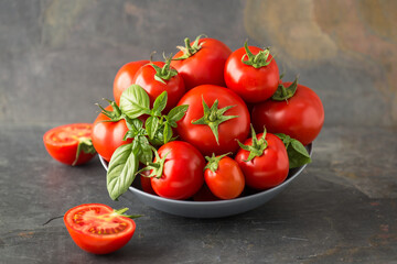  Ripe organic tomatoes and basil in the bowl