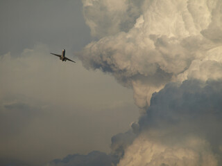 Airplane taking off into a storm at sunset, Barcelona, Spain.