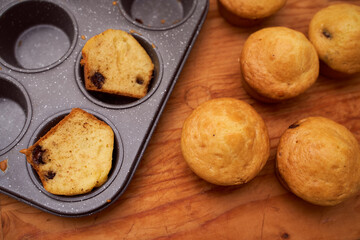 Homemade cupcakes lie on a wooden plate
